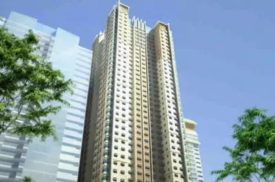 a tall building with many windows in a city at 1 Bed Apartment Sleeps 2 with Parking in Manila