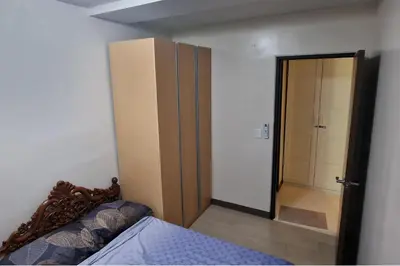 a bedroom with a closet and a bed and a door at 1 Bed Apartment Sleeps 2 with Parking in Manila
