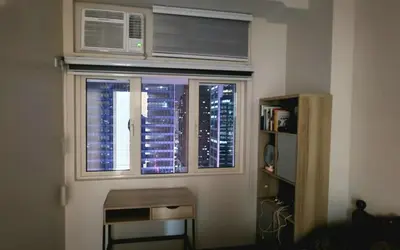 a room with a window with a air conditioner at 1 Bed Apartment Sleeps 2 with Parking in Manila