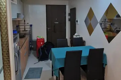 a kitchen with a blue table and chairs in a room at 1 Bed Apartment Sleeps 2 with Parking in Manila