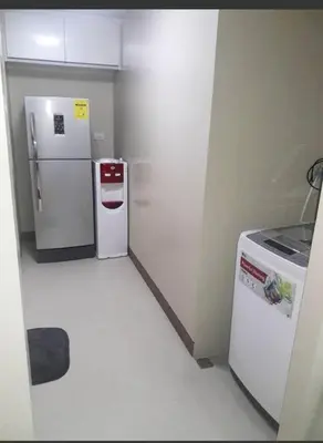 a small kitchen with two refrigerators and a stove at Transient Near Airport by Rqui in Manila