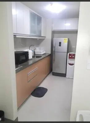 a kitchen with a sink and a refrigerator at Transient Near Airport by Rqui in Manila