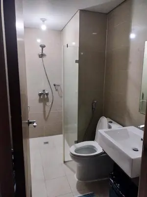 a bathroom with a shower and a toilet and a sink at Transient Near Airport by Rqui in Manila