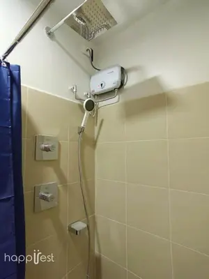 a shower in a bathroom with a shower head at Happirest at Shore 3 Residences with Balcony, Mall of Asia in Manila