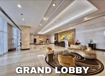 a grand lobby of a hotel with a couch and chairs at Luxury 1BR Unit with Pool at Venice Luxury Residences, Tower Domenico, McKinley Hill, Taguig City in Manila