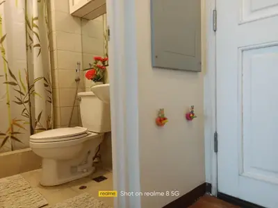 a bathroom with a toilet and a door at WestParc Cedar Alabang in Manila