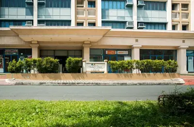 a building with a sign in front of it at WestParc Cedar Alabang in Manila