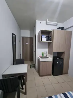 a small kitchen with a sink and a table at Macks Awesome Place 204 NetflixFastWifi in Manila