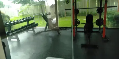 a gym with rows of equipment and a window at Night Blink Staycation And Rentals in Cainta