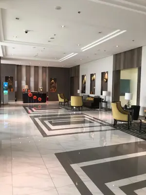 a lobby with chairs and tables in a building at Robles’ Unit at 81 Newport Boulevard in Manila