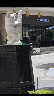 a statue of a white cat standing in front of a building at Robles’ Unit at 81 Newport Boulevard in Manila