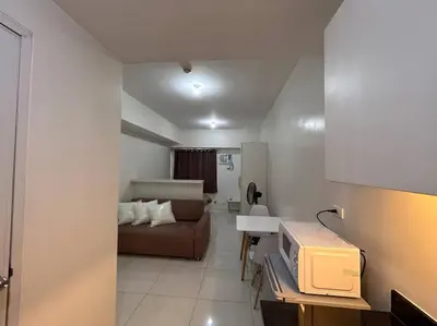 a small living room with a couch and a bedroom at Sweden's Tiny Home, Studio Unit Condo in Manila