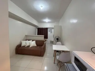 a living room with a couch and a table at Sweden's Tiny Home, Studio Unit Condo in Manila