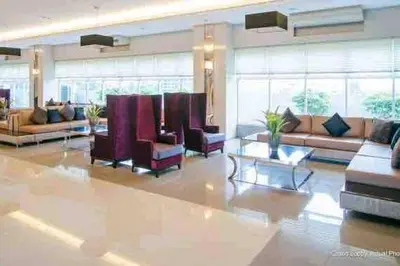 a large lobby with couches and chairs in a building at Sweden's Tiny Home, Studio Unit Condo in Manila