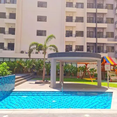 a swimming pool with a gazebo in front of a building at Spring Residences Scandinavian 2 bedrooms with balcony Near NAIA in Manila