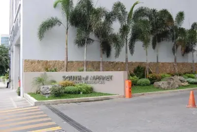 a sign for a university of miami building at BGC Private Apartments in Manila
