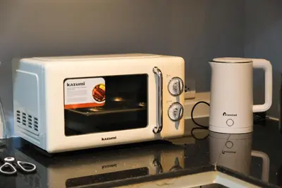 a white toaster oven sitting on top of a counter at BGC Private Apartments in Manila