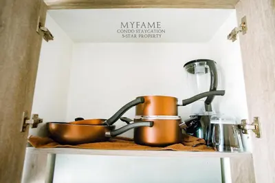 a kitchen shelf with pots and pans on it at 2BR SMDC Premium Unit: FAME Residences 31st FLOOR in Manila