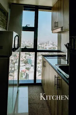 a kitchen with a view of a city at 2BR SMDC Premium Unit: FAME Residences 31st FLOOR in Manila