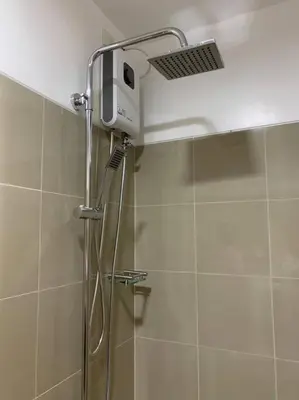 a shower with a shower head in a bathroom at Katei elegantly designed 1-bedroom facing amenity in Manila