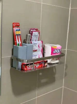 a shelf on the wall in a bathroom with toiletries at Katei elegantly designed 1-bedroom facing amenity in Manila