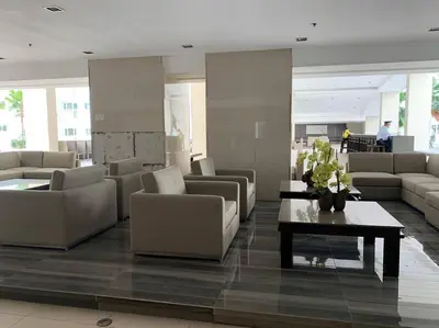 a lobby with couches and a table in a building at Katei elegantly designed 1-bedroom facing amenity in Manila