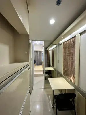 a room with two tables and a table and chairs at Grand Riviera Suits in Manila