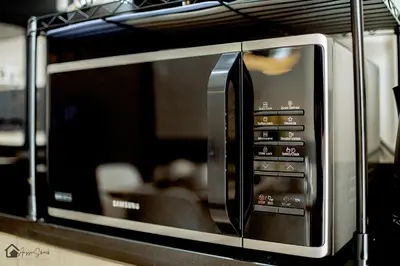 a microwave oven sitting on top of a counter at Aussie Shack - 2BR Modern Condo with Skyline View in Manila