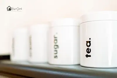 a row of white jars sitting on a shelf at Aussie Shack - 2BR Modern Condo with Skyline View in Manila