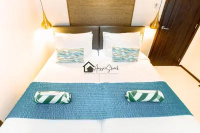 a bed with two pillows on top of it at Aussie Shack - 2BR Modern Condo with Skyline View in Manila