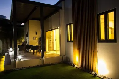 a view of a house with a porch and a patio at Orchard Tiny Home - Golf Course Pet Friendly Lot in Baluctot