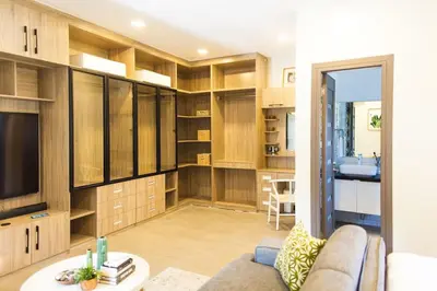 a living room with a couch and a tv at Orchard Tiny Home - Golf Course Pet Friendly Lot in Baluctot