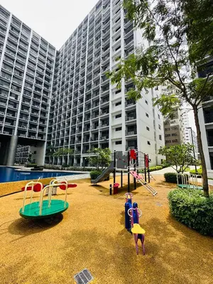 a playground in front of a large building at Victoria’s Place in Manila