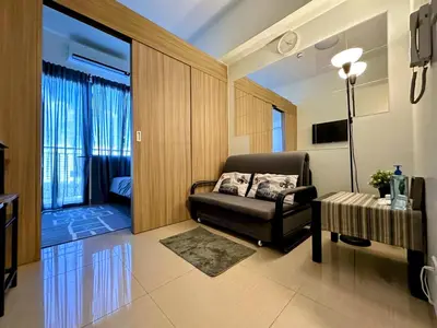 a living room with a leather chair and a table at Victoria’s Place in Manila