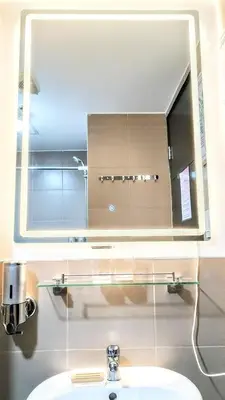 a bathroom with a mirror and a sink at ROARI Portovita Towers Scandinavian Studio Unit in Manila