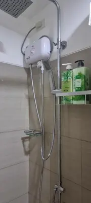 a shower in a bathroom with a shower head at EZStays Shore Residences in Manila