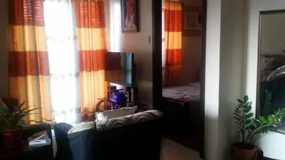 a living room with a mirror and a couch at Rochester Condo in Manila