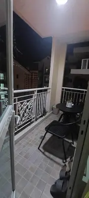 a balcony with a table and a table on a balcony at Rochester Condo in Manila