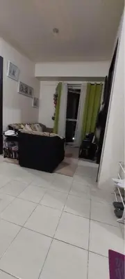a living room with a couch in a room at Rochester Condo in Manila
