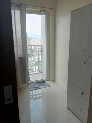 a bathroom with a large window and a white tile floor at Breeze Residences - 1BR Unit with Balcony -Top Floor in Manila