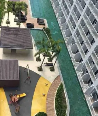 an overhead view of a large building with palm trees at Breeze Residences - 1BR Unit with Balcony -Top Floor in Manila