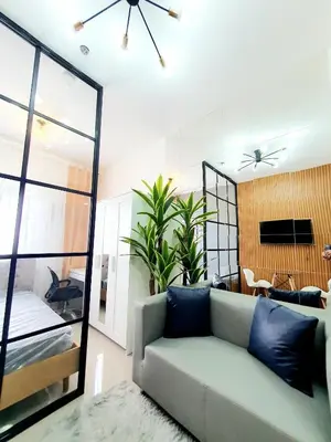 a living room with a couch and a mirror at Green 2 Residences Scandi-Industrial Hotel Type Interior in Dasmariñas