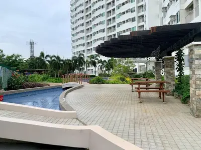 a picnic table and an umbrella next to a pool at Sweet Home with WiFi and Netflix in Manila