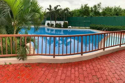 a swimming pool with a fence around it at Sweet Home with WiFi and Netflix in Manila