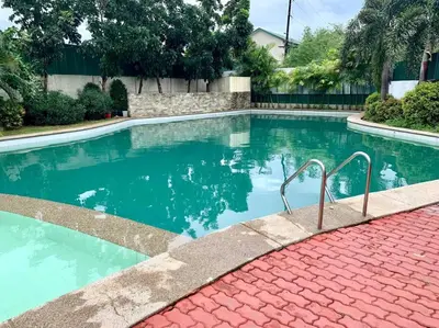a swimming pool with blue water in a house at Sweet Home with WiFi and Netflix in Manila