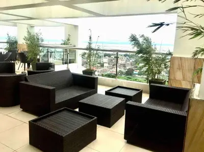 a lobby with couches and tables and a view of the ocean at Sweet Home with WiFi and Netflix in Manila