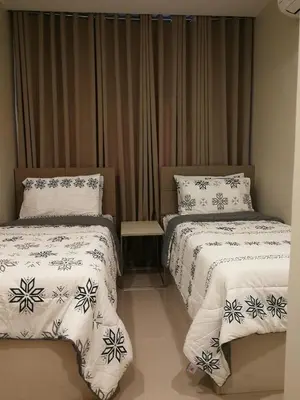 a bedroom with two beds with white and blue sheets at Adria Residences - Ruby Garden - 2 Bedroom for 4 person in Manila