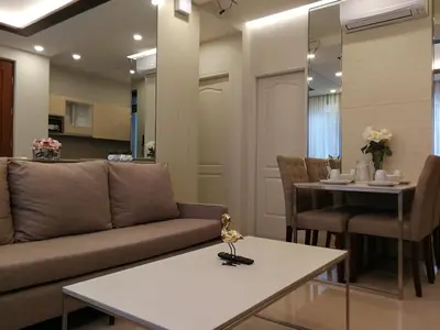 a living room with a couch and a table at Adria Residences - Ruby Garden - 2 Bedroom for 4 person in Manila