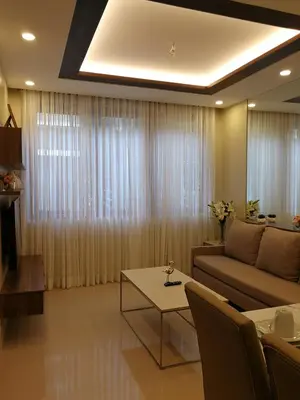 a living room with a couch and a table at Adria Residences - Ruby Garden - 2 Bedroom for 4 person in Manila