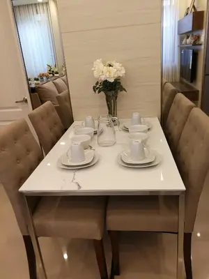 a white table with cups and saucers on it at Adria Residences - Ruby Garden - 2 Bedroom for 4 person in Manila